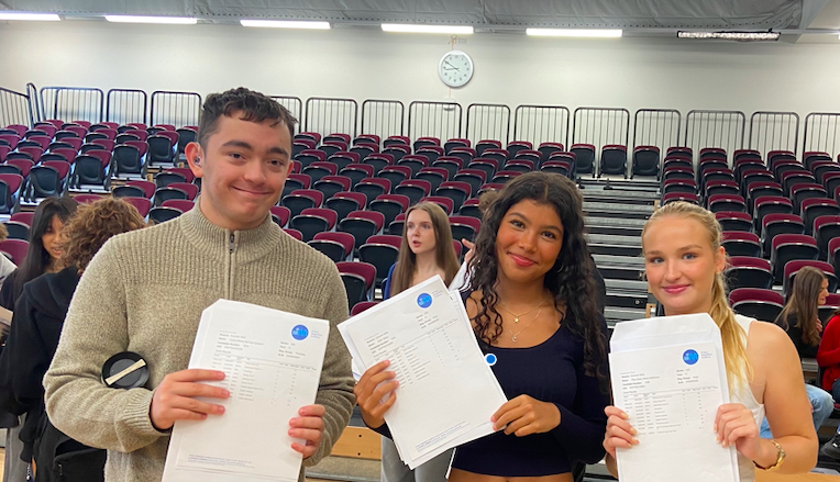 3 SMMA students happily hold up their GCSE results